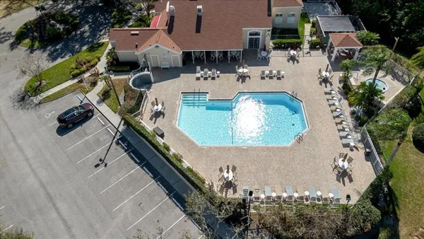 an aerial view of a house with a swimming pool and outdoor seating