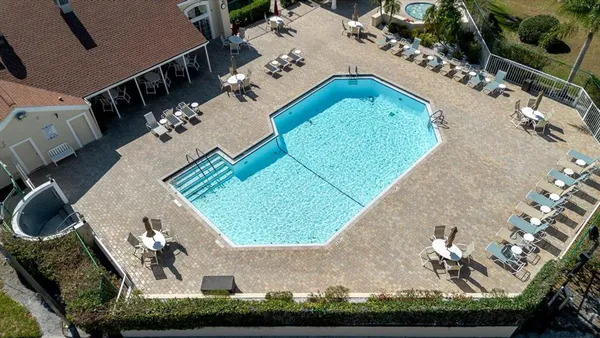an aerial view of a house a yard and outdoor seating