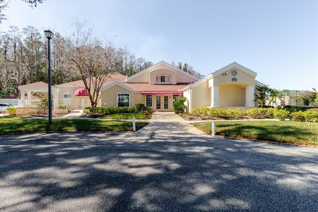 7807 Hardwick Drive, Unit 111 New Port Richey, FL 34653 - Photo 37 of 38 a front view of a house with a yard and garage