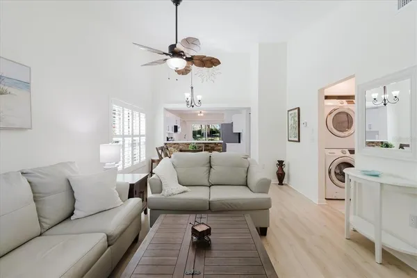a living room with furniture a rug and white walls
