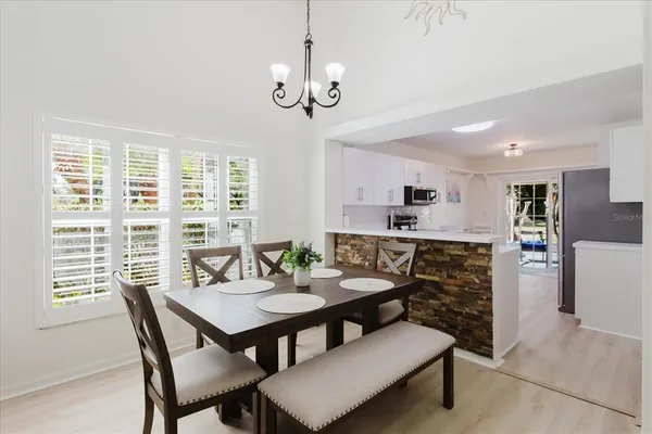 a view of a dining room with furniture window and wooden floor