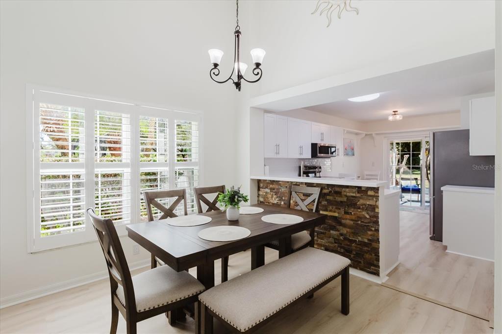 7807 Hardwick Drive, Unit 111 New Port Richey, FL 34653 - Photo 8 of 38 a view of a dining room with furniture window and wooden floor