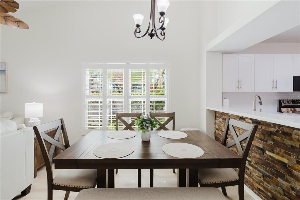 7807 Hardwick Drive, Unit 111 New Port Richey, FL 34653 - Photo 9 of 38 a view of a dining room with furniture and wooden floor