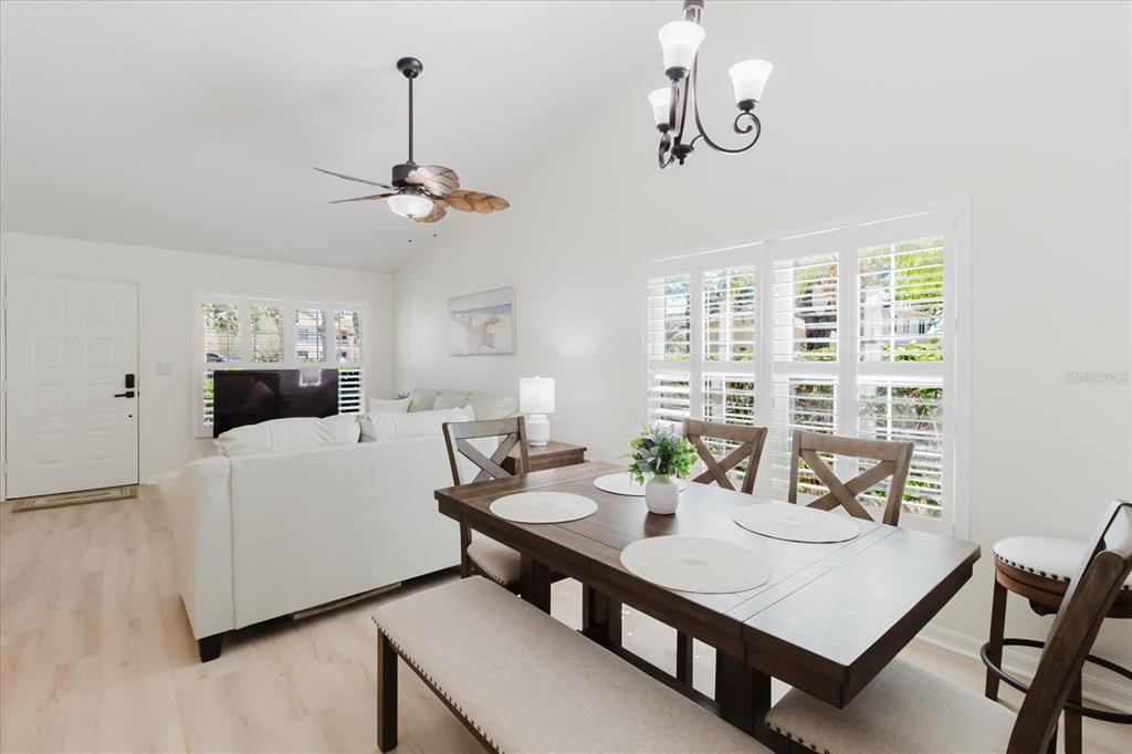 7807 Hardwick Drive, Unit 111 New Port Richey, FL 34653 - Photo 10 of 38 a view of a dining room with furniture window and wooden floor