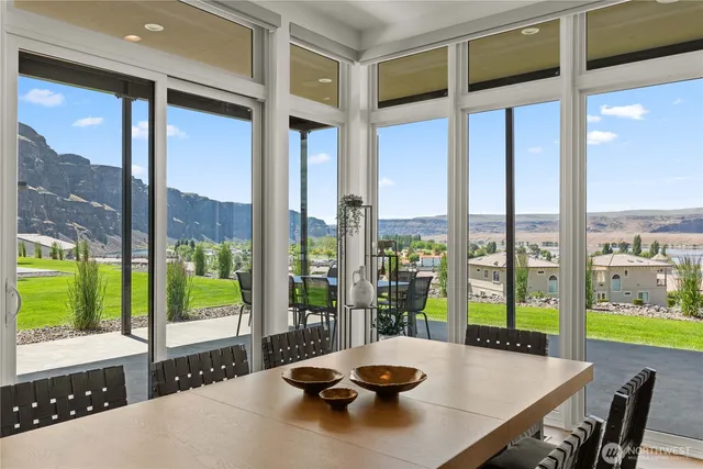 a view of a dining room and floor to ceiling window