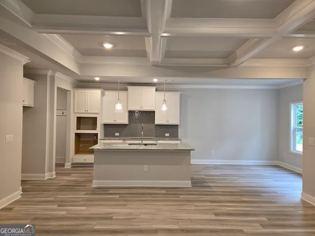 a view of kitchen with cabinets and wooden floor