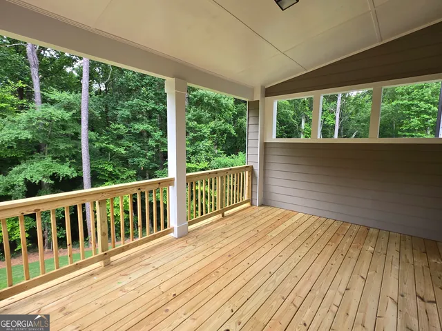 a view of balcony with wooden floor