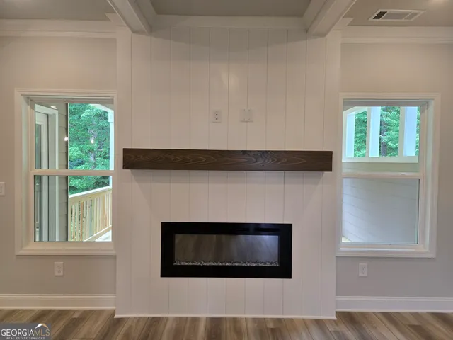 a living room with a fireplace and a window