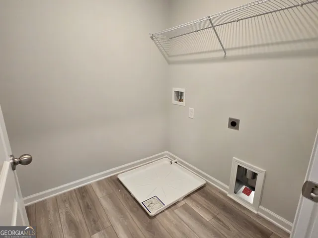 a view of a room with wooden floor and fan