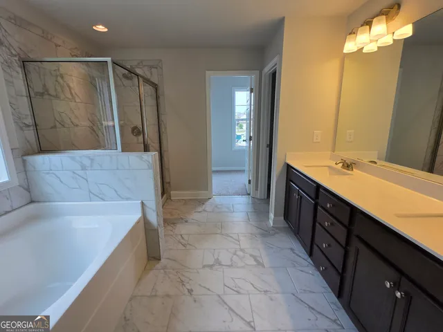 a bathroom with a shower and a bath tub