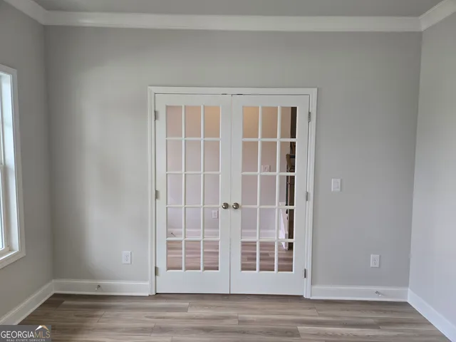 a view of empty room with wooden floor and cabinet