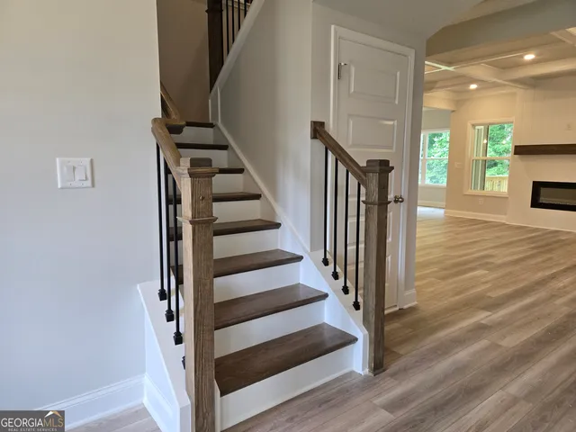 a view of entryway and hall with wooden floor