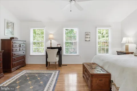 a spacious bedroom with a bed and a window