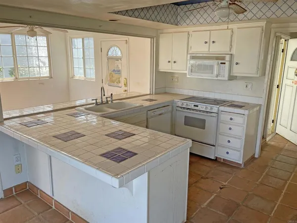 a kitchen with a sink cabinets and window