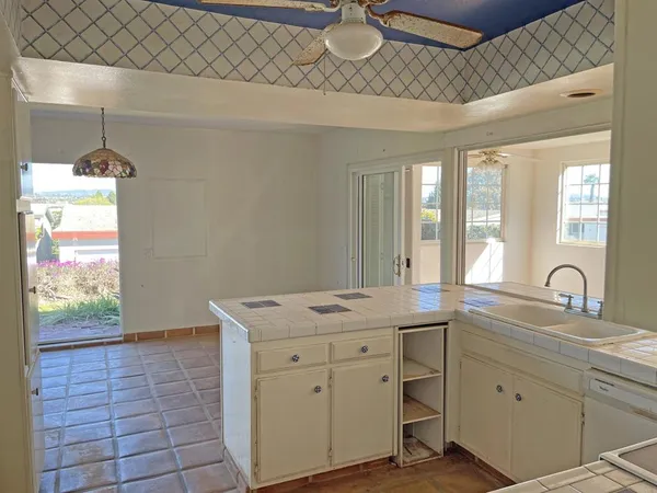 a view of kitchen with windows and cabinet