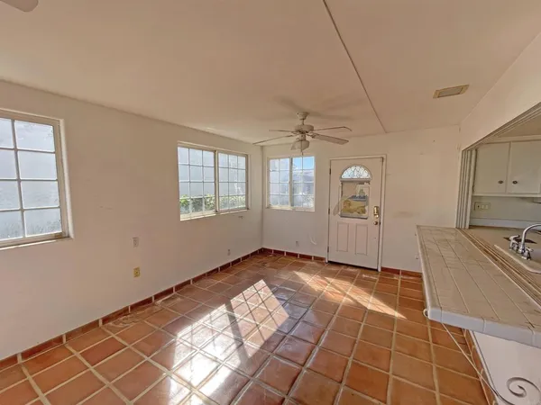 a living room with furniture a flat screen tv and a table