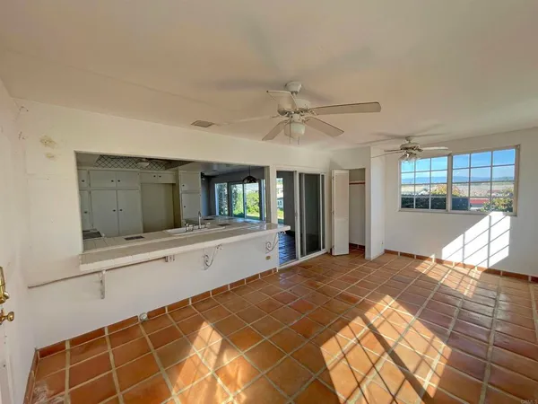 a living room with white furniture and a table