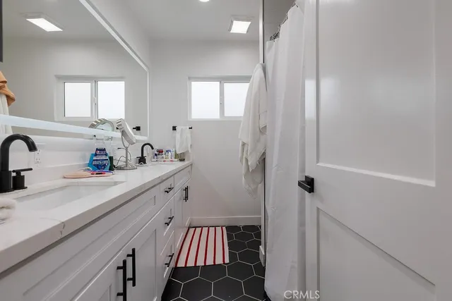 a bedroom with a bed and a mirror