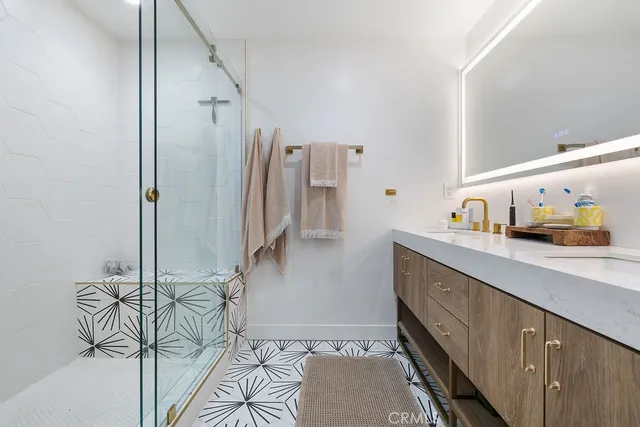 a bathroom with a sink a mirror and a shower