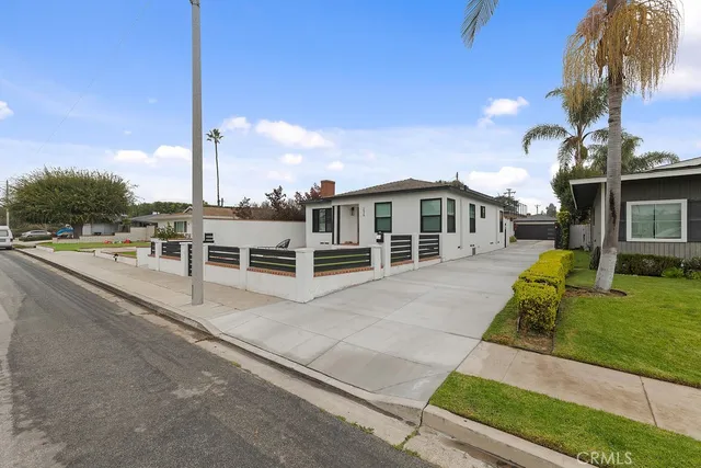 a large kitchen with stainless steel appliances granite countertop a lot of counter space and wooden floors
