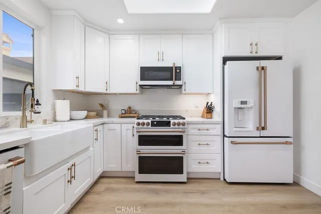 a view of a roof deck with table and chairs floor to ceiling window and wooden floor