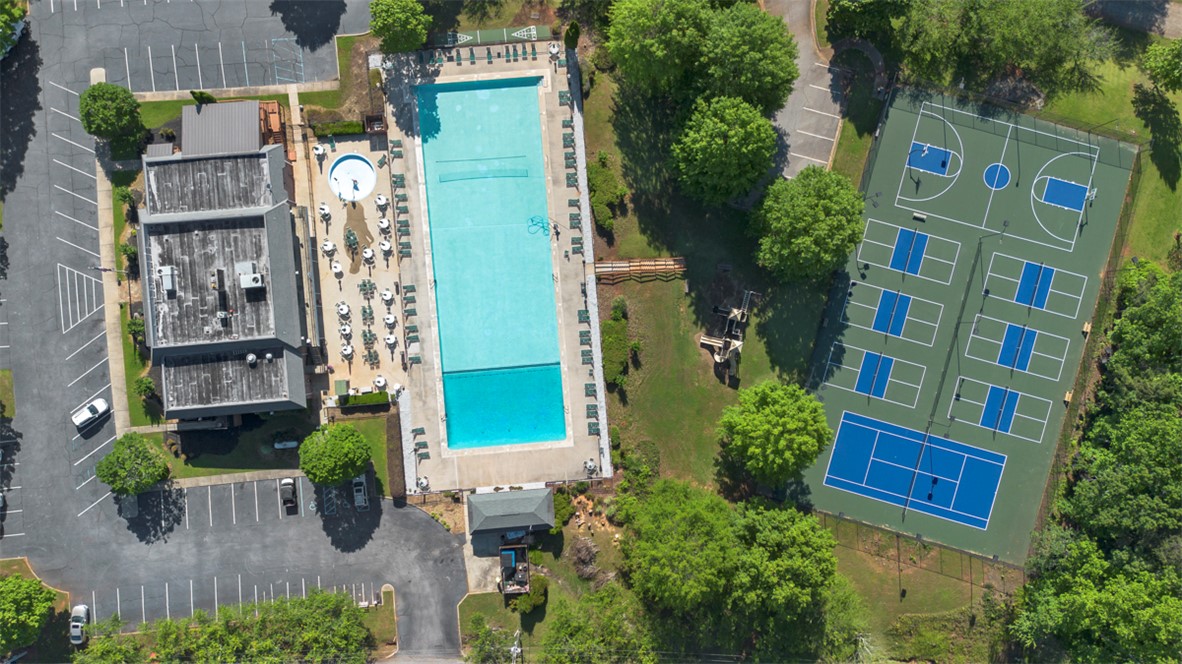 118 Choestoea Road Westminster, SC 29693 - Photo 2 of 8 An aerial perspective reveals a vibrant community with recreational amenities including an inviting pool and multiple sports courts.