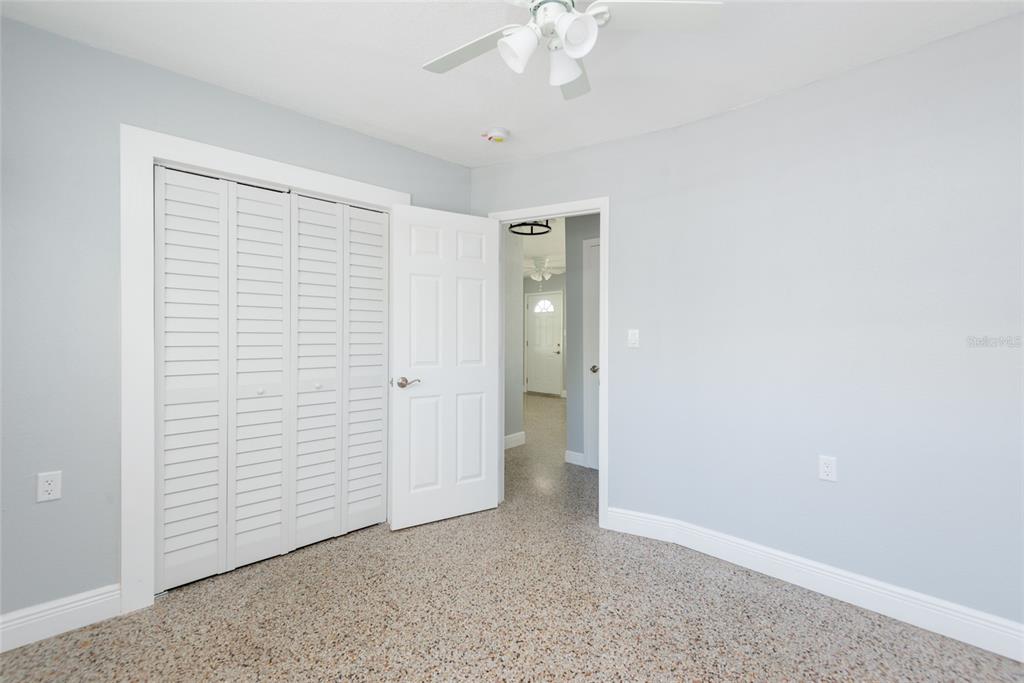 13248 4th Street East Madeira Beach, FL 33708 - Photo 13 of 47 an empty room with a ceiling fan
