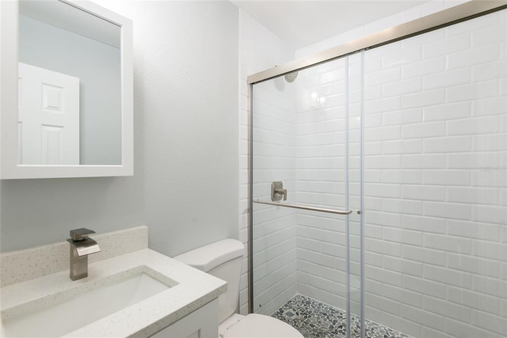 13248 4th Street East Madeira Beach, FL 33708 - Photo 14 of 47 a bathroom with a sink a toilet and shower