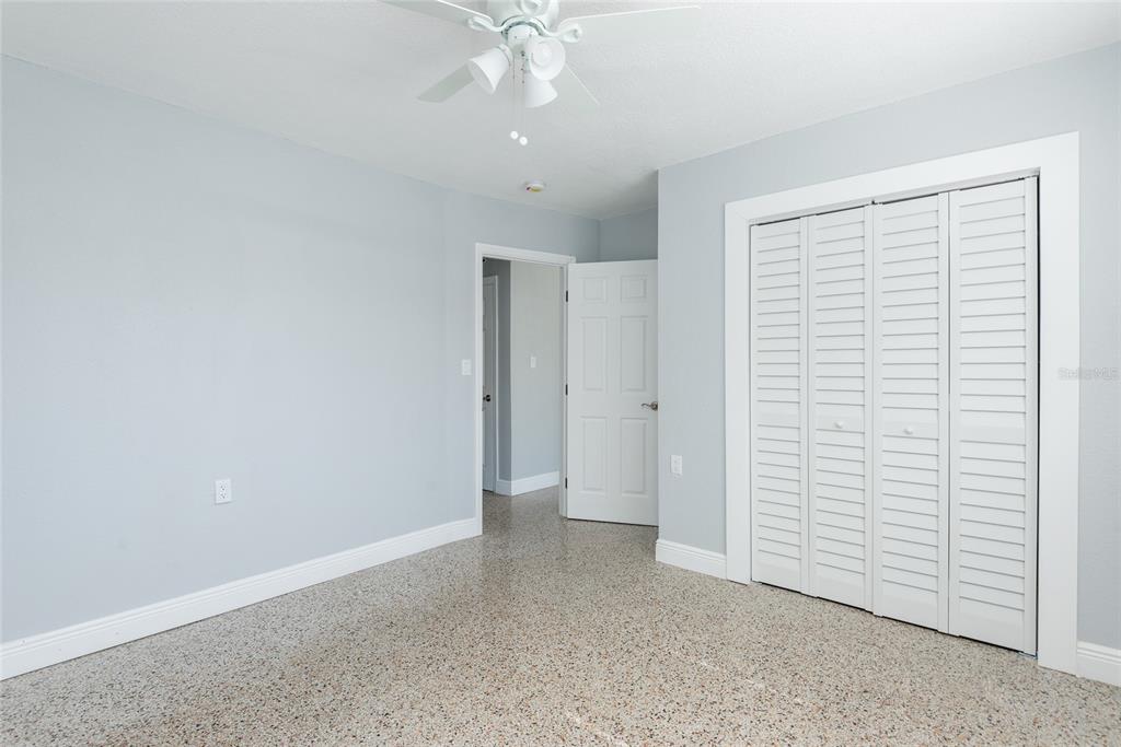 13248 4th Street East Madeira Beach, FL 33708 - Photo 26 of 47 an empty room with a ceiling fan