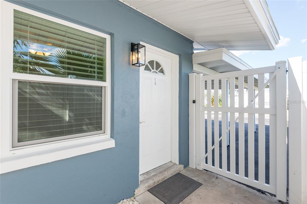 13248 4th Street East Madeira Beach, FL 33708 - Photo 4 of 47 a view of a livingroom with a white door and wooden floor