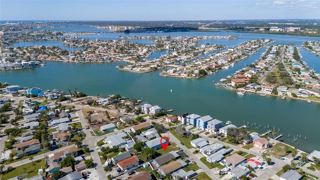 13248 4th Street East Madeira Beach, FL 33708 - Photo 43 of 47 an aerial view of water body with boats and trees in the background