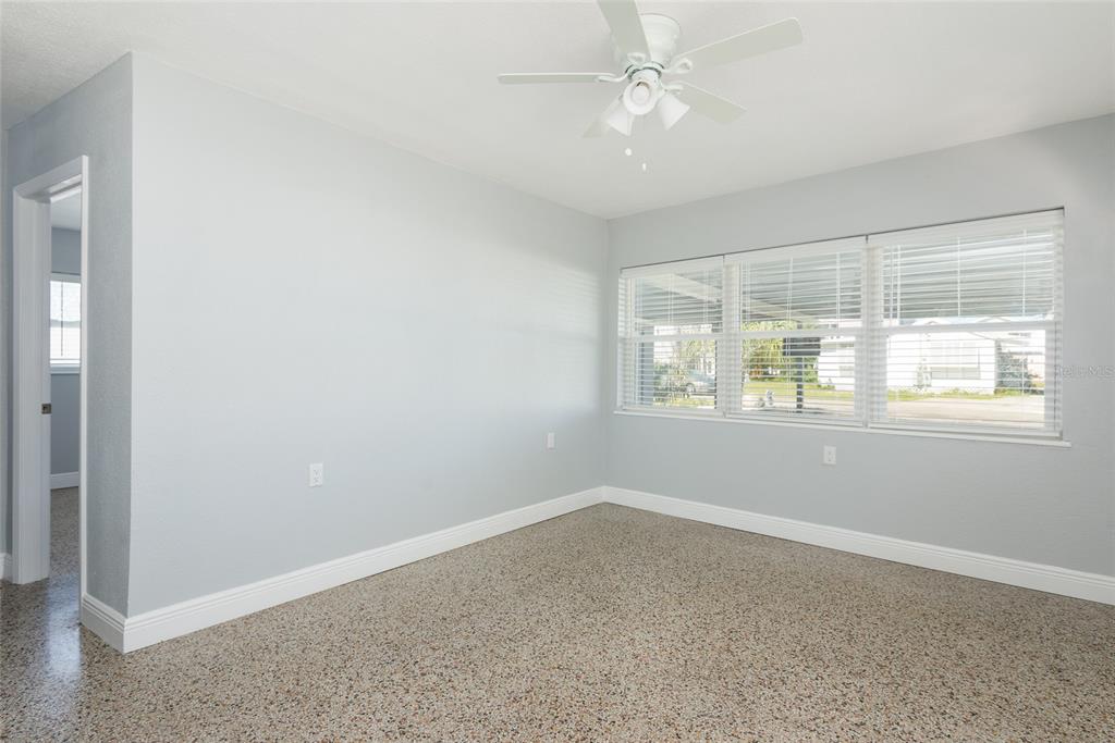 13248 4th Street East Madeira Beach, FL 33708 - Photo 7 of 47 an empty room with a window and a fan