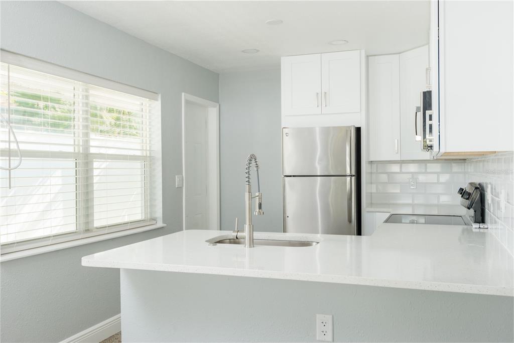 13248 4th Street East Madeira Beach, FL 33708 - Photo 9 of 47 a bathroom with a sink and a large mirror
