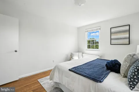 a living room with a bed and a window