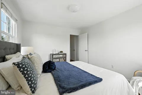 a bedroom with a bed a couch and dresser