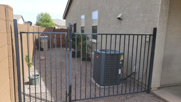 a couple of flower plants in front of house