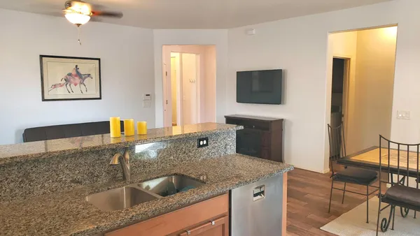 a kitchen with a sink a counter top space and cabinets