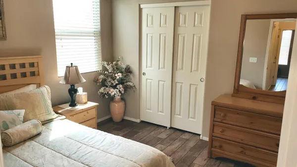 a bathroom with a granite countertop sink toilet a large mirror and a tub
