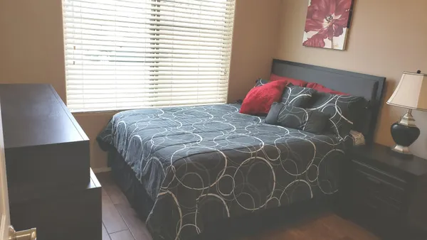 a bedroom with a bed and a window