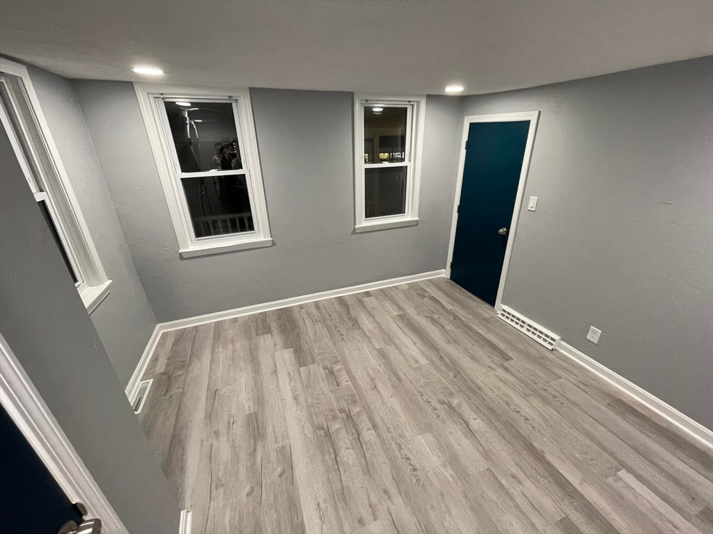 7 Coolidge Street Hudson, MA 01749 - Photo 12 of 40 a view of empty room with wooden floor and fan
