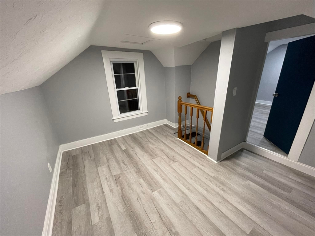 7 Coolidge Street Hudson, MA 01749 - Photo 16 of 40 a view of an empty room with wooden floor and a window