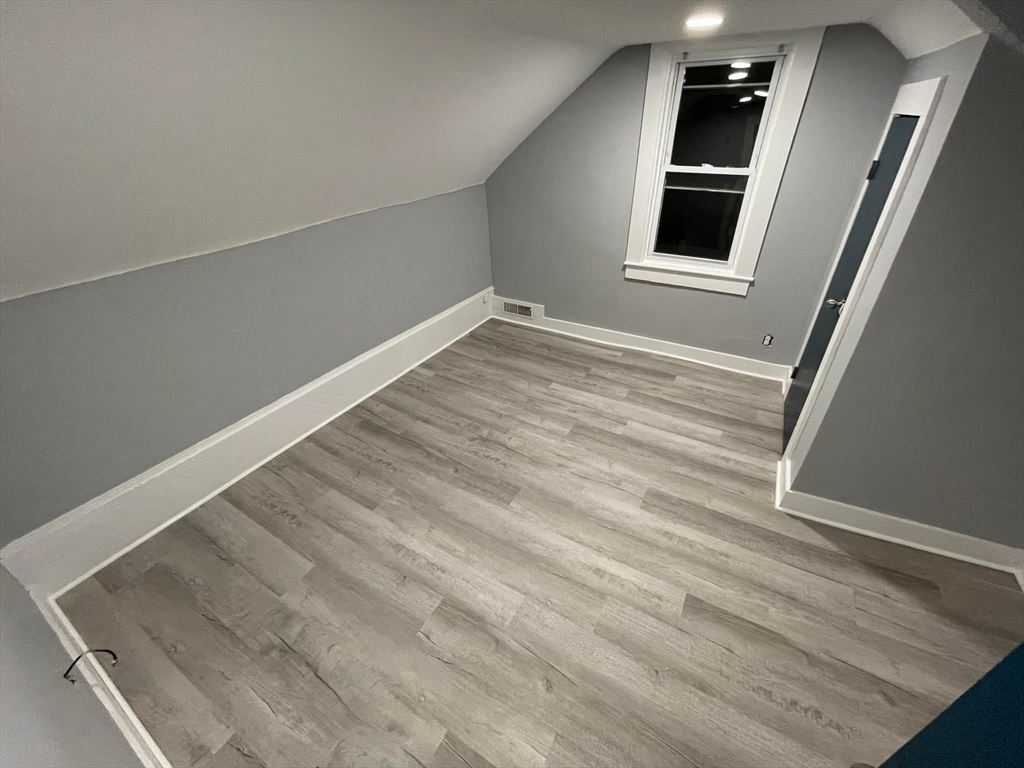 7 Coolidge Street Hudson, MA 01749 - Photo 21 of 40 a view of an empty room with wooden floor and closet