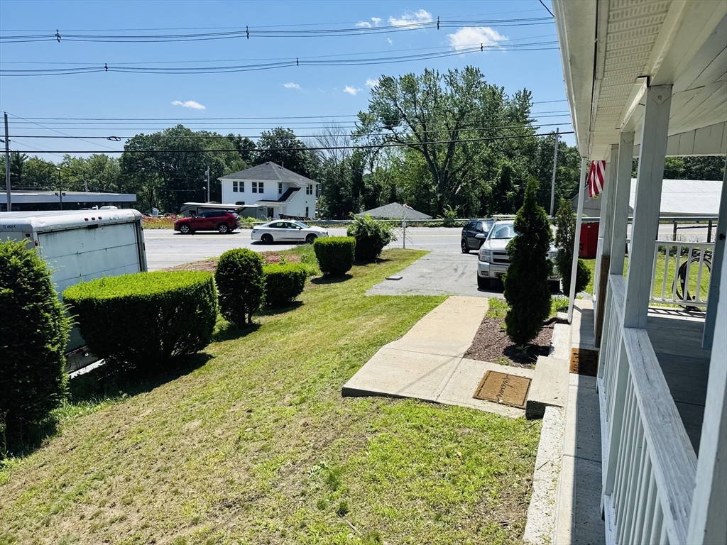 7 Coolidge Street Hudson, MA 01749 - Photo 32 of 40 a view of a patio with table and chairs potted plants with wooden floor
