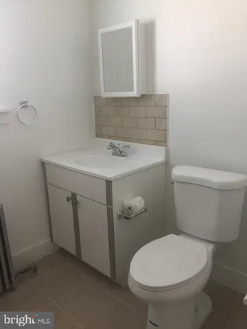 a white toilet sitting next to a bathroom sink