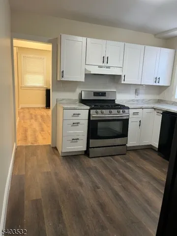 a kitchen with stainless steel appliances granite countertop a stove and a sink