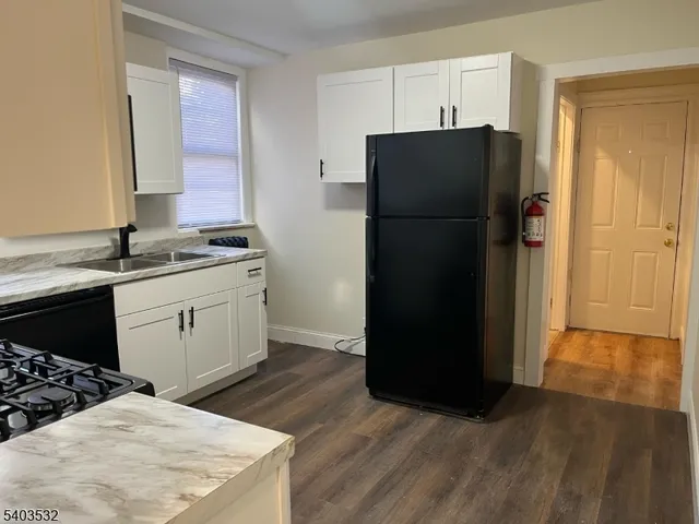 a kitchen with a refrigerator and a sink