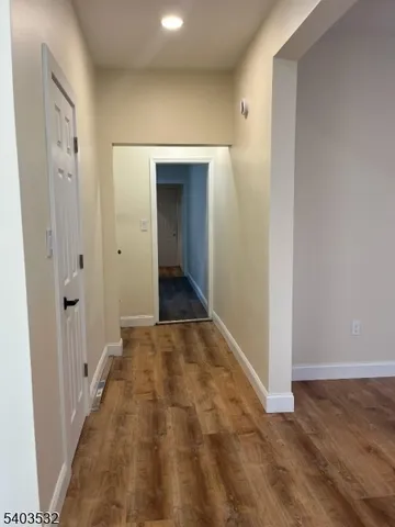 a view of hallway with wooden floor