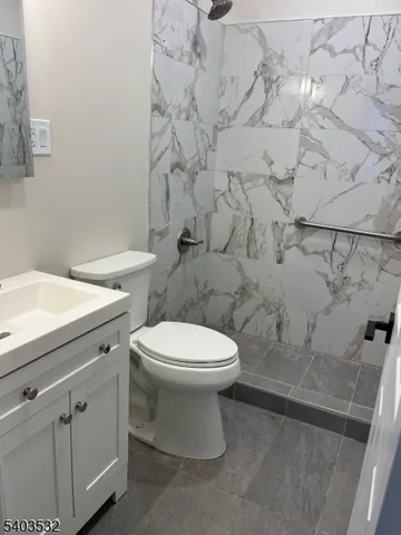 a white toilet sitting next to a bathroom sink