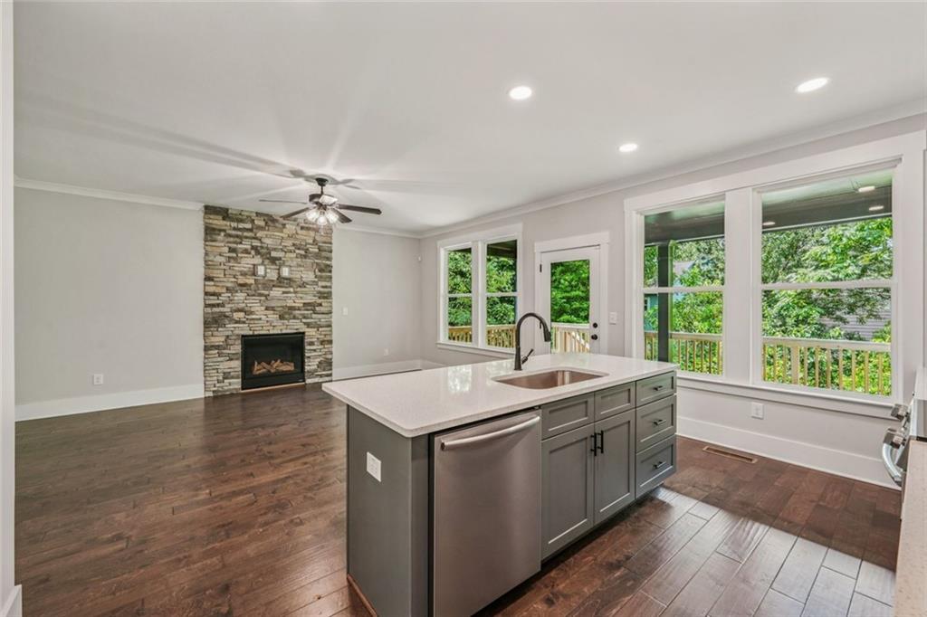 1179 Booker Avenue Southwest Atlanta, GA 30310 - Photo 13 of 54 a room with kitchen island a sink and a fireplace