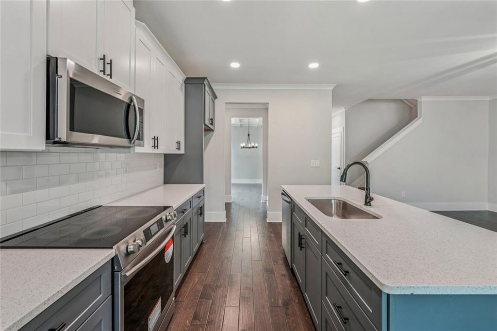 1179 Booker Avenue Southwest Atlanta, GA 30310 - Photo 14 of 54 a kitchen with a sink stove and microwave